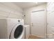 Functional laundry area with modern appliances and overhead shelving at 2704 Polo Club Blvd, Matthews, NC 28105
