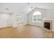 Bright living room with vaulted ceiling, fireplace, hardwood floors, and natural light at 2704 Polo Club Blvd, Matthews, NC 28105