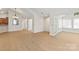 Open concept living room with hardwood floors, neutral paint, and a view of a sunroom at 2704 Polo Club Blvd, Matthews, NC 28105