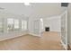 Bright living room with hardwood floors, neutral paint, and a doorway to another room at 2704 Polo Club Blvd, Matthews, NC 28105
