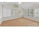 Sunroom with vaulted ceiling, hardwood floors, and large windows providing natural light at 2704 Polo Club Blvd, Matthews, NC 28105