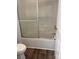 Bathroom tub and shower featuring sliding glass doors and white walls at 2800 Deans Ct, Monroe, NC 28110