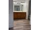 Bathroom featuring a double vanity with wood cabinets and modern lighting at 2800 Deans Ct, Monroe, NC 28110