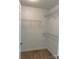 Walk-in closet with white walls, carpeted floors, and wire shelving units at 2800 Deans Ct, Monroe, NC 28110