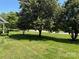 Manicured front yard featuring a lush lawn and mature shade trees at 2800 Deans Ct, Monroe, NC 28110