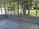 Enclosed sunroom showcasing tiled flooring and views of the backyard at 2800 Deans Ct, Monroe, NC 28110