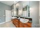 Bathroom with double sinks, granite countertops, stylish fixtures, and lots of natural light from the large window at 2988 Textile Way, Charlotte, NC 28205