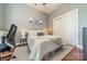 Cozy bedroom with a neutral color palette, featuring a plush bed, sliding closet doors, and hardwood floors at 2988 Textile Way, Charlotte, NC 28205