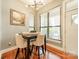 Cozy dining area featuring a black table, seating for four, wood floors, and lots of natural light from the windows at 2988 Textile Way, Charlotte, NC 28205