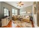 Comfortable living room with a large sectional sofa, ceiling fan, area rug, and big screen TV, perfect for relaxing at 2988 Textile Way, Charlotte, NC 28205