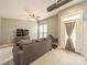 Inviting living room with neutral carpet, gray sofa, and access to outdoor space at 2988 Textile Way, Charlotte, NC 28205