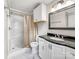 Bathroom featuring a shower and vanity with a black countertop and white cabinetry at 326 N Greenbriar Rd, Statesville, NC 28625