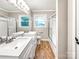 Bright bathroom featuring double sinks with a glass-enclosed shower and a large window at 326 N Greenbriar Rd, Statesville, NC 28625