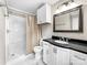 Bathroom featuring a shower and vanity with a black countertop and white cabinetry at 326 N Greenbriar Rd, Statesville, NC 28625