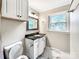 Bathroom featuring a vanity with a black countertop and white cabinetry and marble flooring at 326 N Greenbriar Rd, Statesville, NC 28625