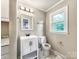 Bathroom featuring a white vanity, modern fixtures, and marble-look flooring at 326 N Greenbriar Rd, Statesville, NC 28625