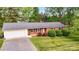 Charming brick ranch home featuring an attached garage, well-manicured lawn, and mature landscaping at 326 N Greenbriar Rd, Statesville, NC 28625