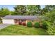 Charming single-story brick home features manicured front lawn and attached one car garage at 326 N Greenbriar Rd, Statesville, NC 28625