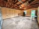 Unfinished garage space with exposed wooden ceiling beams and concrete flooring at 326 N Greenbriar Rd, Statesville, NC 28625