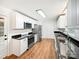 Bright kitchen features white cabinets, stainless steel appliances, and dark countertops at 326 N Greenbriar Rd, Statesville, NC 28625