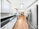 Open concept kitchen with white cabinets, stainless appliances, and hardwood floors at 326 N Greenbriar Rd, Statesville, NC 28625