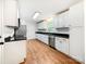 Well-lit kitchen with white cabinets, stainless steel appliances, and sleek black countertops at 326 N Greenbriar Rd, Statesville, NC 28625