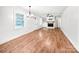 Bright living room boasts hardwood floors, a brick fireplace, and natural light at 326 N Greenbriar Rd, Statesville, NC 28625