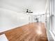 Open living room with hardwood floors, a ceiling fan, and a view into the kitchen at 326 N Greenbriar Rd, Statesville, NC 28625