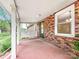 Covered brick porch, with red painted floor, offers a welcoming outdoor space at 326 N Greenbriar Rd, Statesville, NC 28625