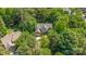 Secluded home surrounded by mature trees and lush greenery as seen from an aerial view at 3710 Cheleys Ridge Ln, Charlotte, NC 28270