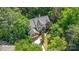 Aerial view of a charming brick and siding home surrounded by lush greenery and trees at 3710 Cheleys Ridge Ln, Charlotte, NC 28270