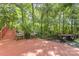 A backyard with deck offers outdoor seating and dining space, surrounded by lush greenery at 3710 Cheleys Ridge Ln, Charlotte, NC 28270