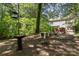 The wooded backyard features a seating area, providing a peaceful outdoor retreat with room to roam at 3710 Cheleys Ridge Ln, Charlotte, NC 28270