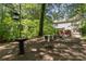 The wooded backyard features a seating area, providing a peaceful outdoor retreat with room to roam at 3710 Cheleys Ridge Ln, Charlotte, NC 28270