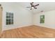 Bright bedroom features hardwood floors, two large windows, and a ceiling fan at 3710 Cheleys Ridge Ln, Charlotte, NC 28270