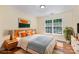 Bright bedroom with large window, light hardwood floors, and neutral walls at 3710 Cheleys Ridge Ln, Charlotte, NC 28270