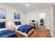 Bright bedroom with two beds, hardwood floors, and a closet; perfect for or guests at 3710 Cheleys Ridge Ln, Charlotte, NC 28270