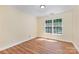 Bright bedroom with light-colored walls, wood floors, and a large window offering natural light at 3710 Cheleys Ridge Ln, Charlotte, NC 28270
