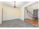 Dining room showcasing tile flooring connecting to the entry hall with wooden staircase at 3710 Cheleys Ridge Ln, Charlotte, NC 28270