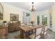 Staged dining room featuring an exposed wood table, view of front door and large sun-filled windows at 3710 Cheleys Ridge Ln, Charlotte, NC 28270