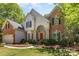 Charming brick and siding home featuring a red front door and well-maintained landscaping at 3710 Cheleys Ridge Ln, Charlotte, NC 28270