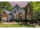 Charming brick and siding home featuring a red front door and well-maintained landscaping at 3710 Cheleys Ridge Ln, Charlotte, NC 28270