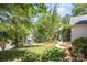 Well-manicured front yard with lush green grass, mature trees, and a charming walkway at 3710 Cheleys Ridge Ln, Charlotte, NC 28270