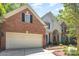 Exterior showcasing a spacious two-car garage, brick siding and manicured landscaping at 3710 Cheleys Ridge Ln, Charlotte, NC 28270