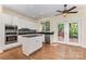 Bright kitchen featuring white cabinets, stainless appliances, and wood flooring at 3710 Cheleys Ridge Ln, Charlotte, NC 28270