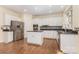 Bright kitchen featuring white cabinets, granite counters, stainless appliances, and wood flooring at 3710 Cheleys Ridge Ln, Charlotte, NC 28270