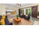 Open-concept living room with modern furniture, sliding barn doors, and seamless flow to the kitchen at 3710 Cheleys Ridge Ln, Charlotte, NC 28270