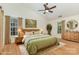 Bright main bedroom with a wooden frame bed, soft green linens, and natural lighting at 3710 Cheleys Ridge Ln, Charlotte, NC 28270