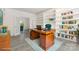 Sunlit home office with custom built-in shelving, a wooden desk, and French doors leading to another room at 3710 Cheleys Ridge Ln, Charlotte, NC 28270