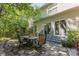 An outdoor stone patio features an outdoor dining set, perfect for entertaining and al fresco meals at 3710 Cheleys Ridge Ln, Charlotte, NC 28270